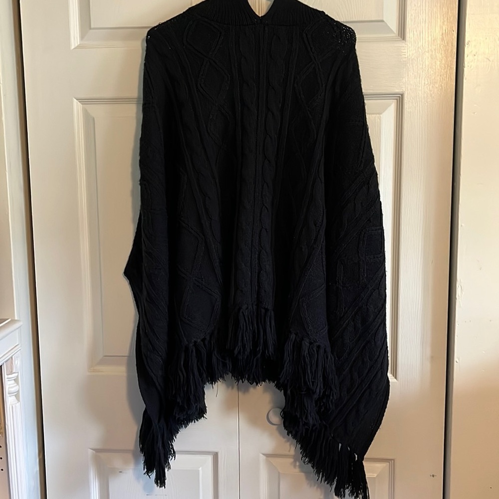 Ladies knit black cape sweater.